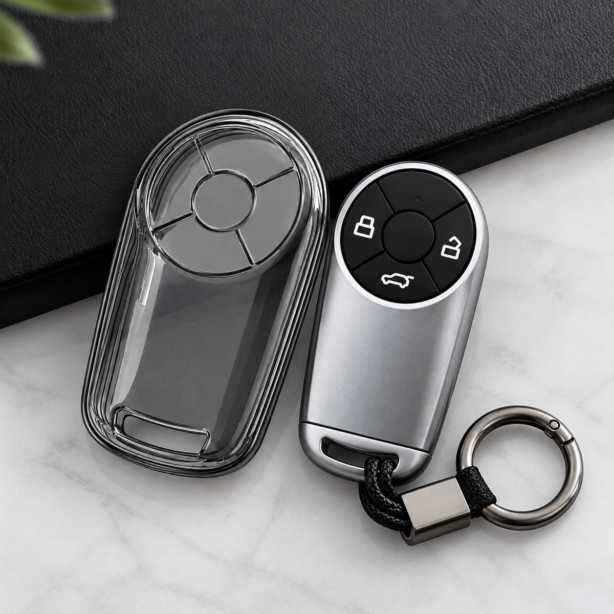 GWM ORA transparent TPU key case cover shown beside matching silver key fob in a clean product view