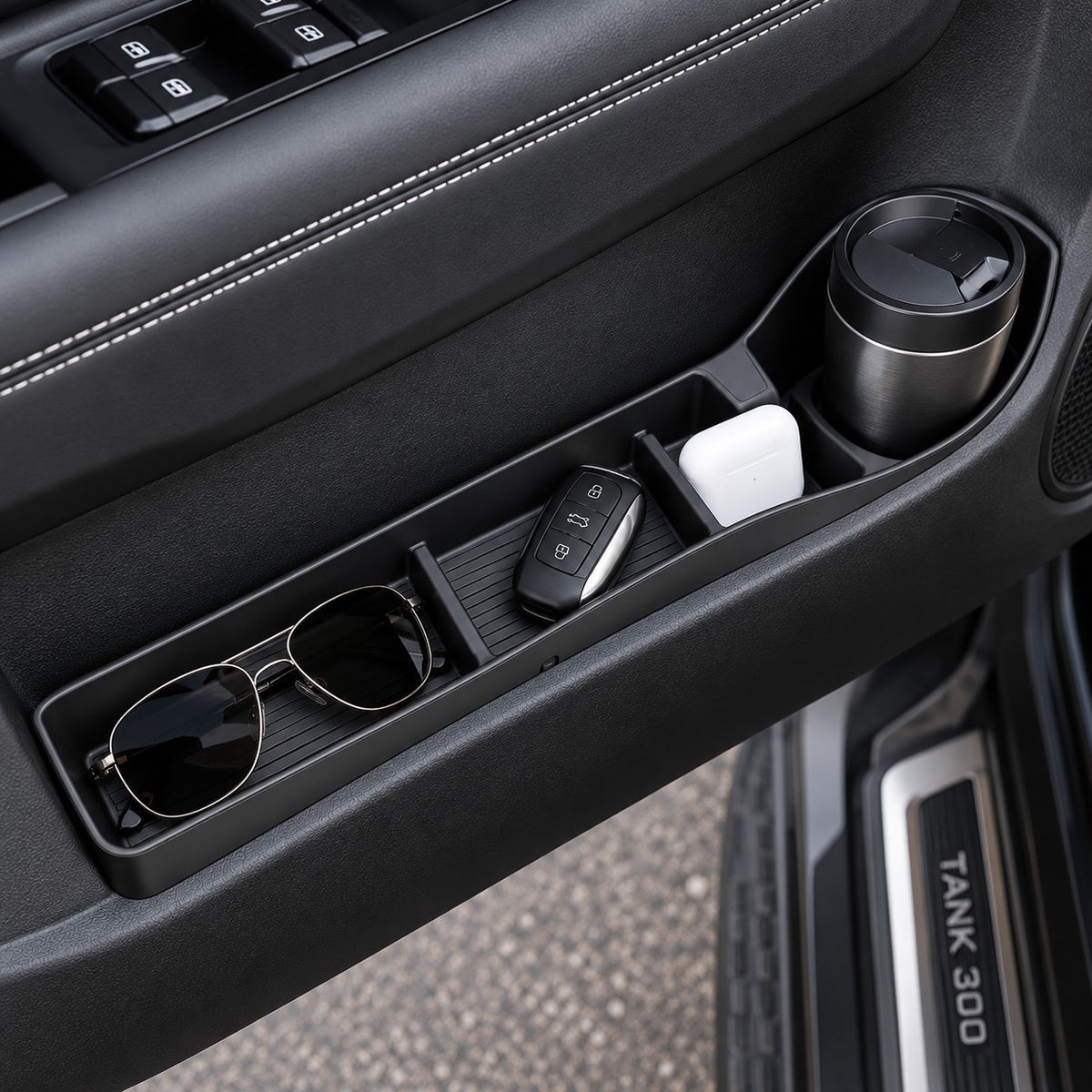 GWM Tank 300 black door pocket organizer with cup holder holding sunglasses key fob wireless earbuds and travel tumbler
