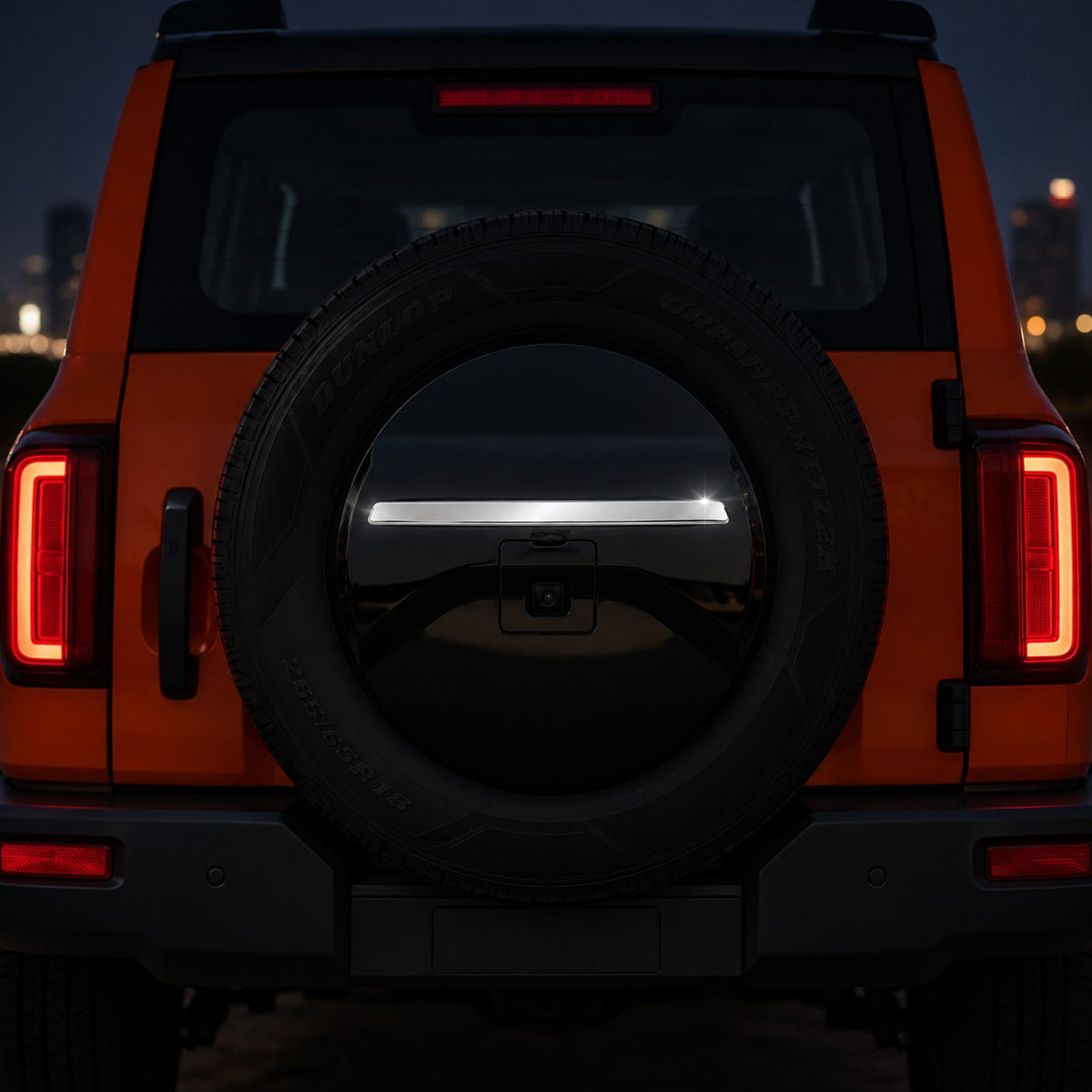GWM Tank 300 rear spare tire cover strip installed at night with the glossy silver trim highlighted on the spare tire cover