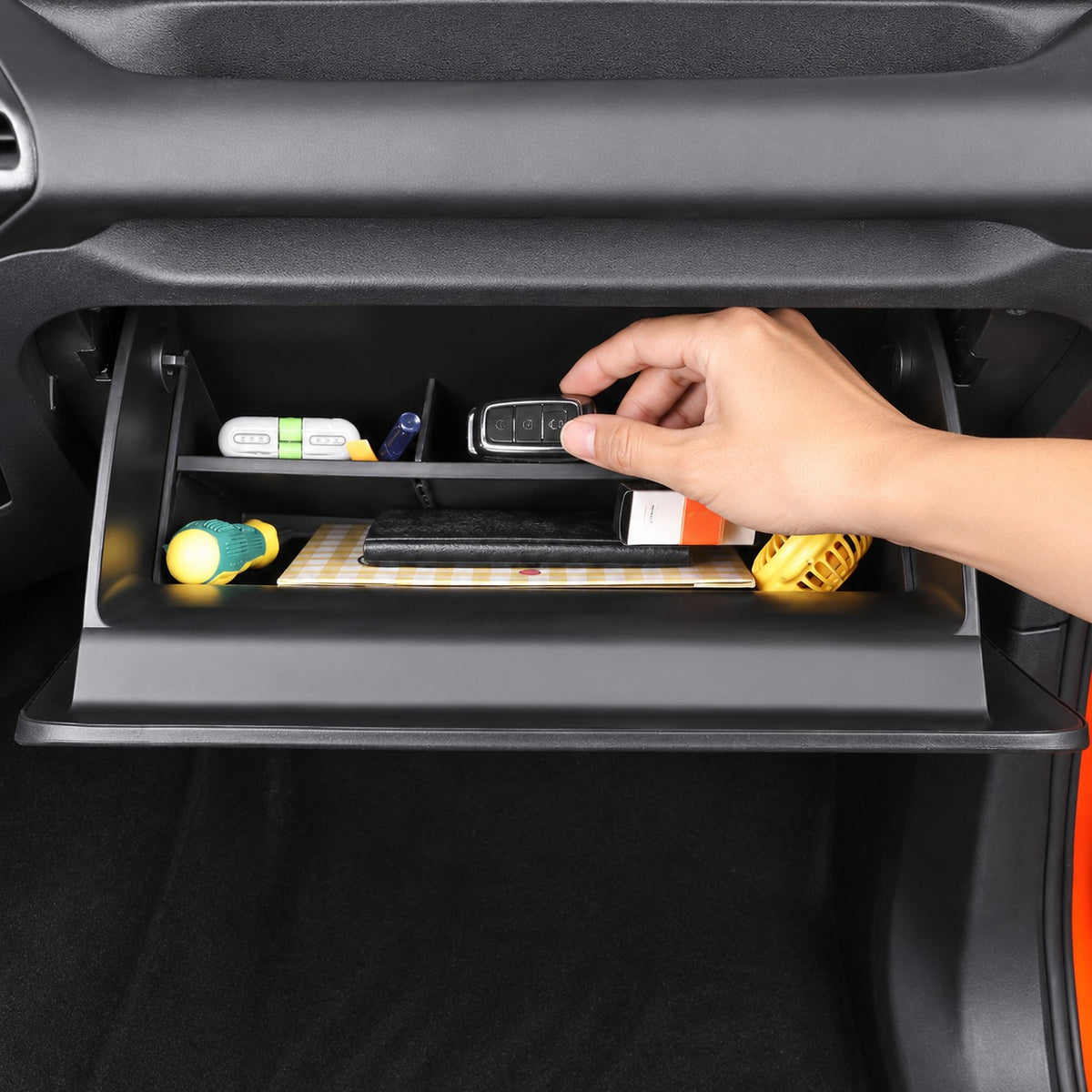 Great Wall TANK 300 glove box organizer being used to retrieve an essential item from the compartment